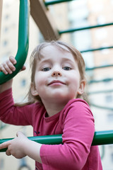 cute smiling girl on outdoor playground background