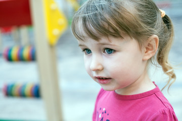 cute smiling girl on outdoor playground background