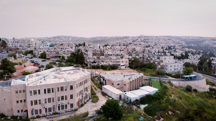 Fototapeta na wymiar Flying over orthodox jewish neighborhood in Jerusalem Aerial view over Ramot orthodox jewish neighborhood in Jerusalem