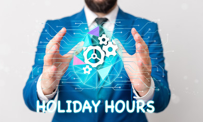 Text sign showing Holiday Hours. Business photo text employee receives twice their normal pay for all hours Male human wear formal work suit presenting presentation using smart device