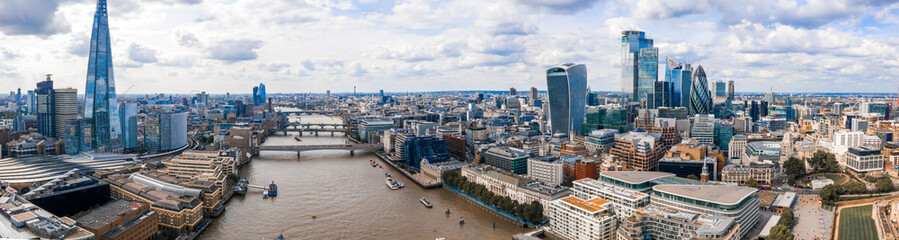 Flying over London. Aerial view of the river Thames, city of London district, and modern skyscrapers. 