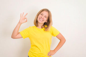 Portrait of a cheerful teenager girl showing okay gesture. Health, education and people concept.