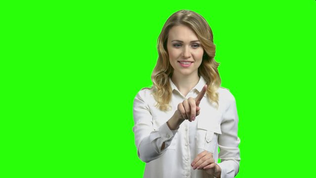 Business woman touching imaginary screen. Pretty office woman pressing button on virtual screen, chroma key background. Concept of online business.