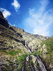 Fototapeta na wymiar Summer landscape with waterfall in the mountains. Capra Waterfall, Fagaras. 