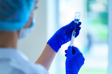 Vaccination of people during an epidemic and viral infectious diseases. Using syringe for injection...