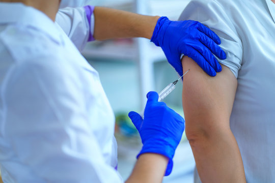 Nurse vaccinated patient against flu and measles during an epidemic. Flu shot, protection and prevention of viral infectious diseases