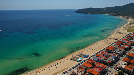 Fototapeta premium Aerial drone photo of famous village and long sandy beach of Sarti in South Sithonia, Halkidiki, Greece