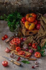 Naklejka na ściany i meble Tomatoes on cutting board with knife, top view