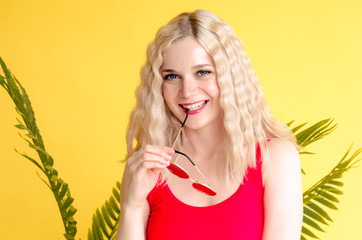 Beautiful stylish girl biting sunglasses