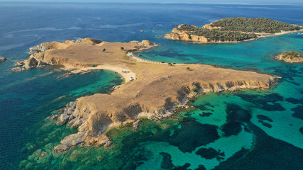 Obraz premium Aerial drone view of paradise small secluded island complex of Drenia and Pena with turquoise and sapphire sea near famous Amouliani island in North Greece, Halkidiki