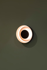 LED lamp, beautiful round wall lamp, soft beautiful light interior design. Isolated on a dark background