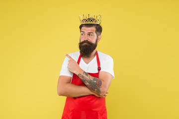 Premium quality. Cook food. Cook with beard and mustache yellow background. Royal recipe. Man king cook wear cooking apron and golden crown. Kingdom of tastes. Chief cook and professional culinary
