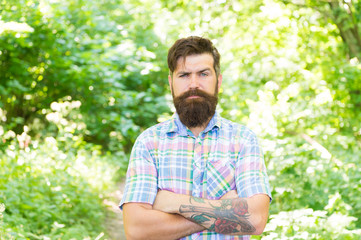 Naklejka na ściany i meble Eco lifestyle. United with environment. Handsome lumberjack. Man beard and mustache in summer forest. Summer vacation concept. Man bearded hipster green trees background. Guy relax in summer nature