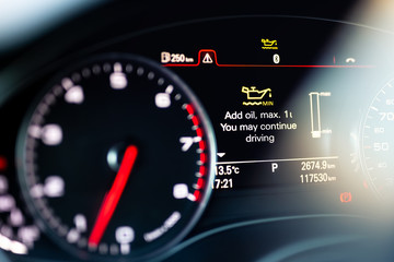 Luxury car color screen dashboard with warning message. Low engine oil level indication....