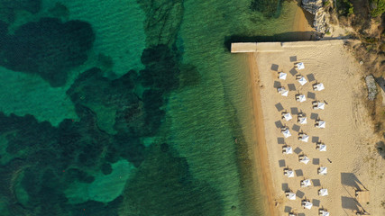 Aerial drone top down view of Mediterranean organised sandy beach with sun beds and umbrellas
