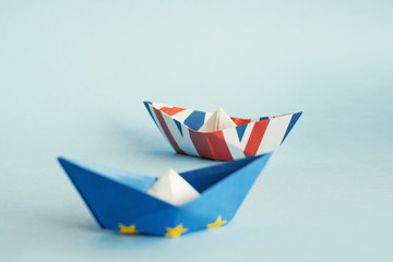 paper ships from the flags of the European Union and the UK on a blue background,  concept of an agreement on Brexit