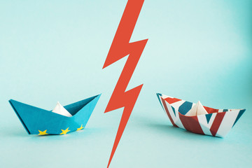 paper ships from the flags of the European Union and the UK on a blue background,  concept of an agreement on Brexit