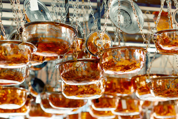 Copper ware, serpentine and jugs on the shop window in the store.