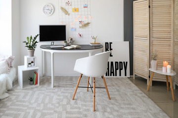 Workplace with mood board and computer in modern room