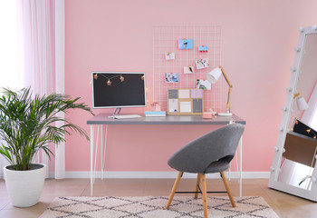 Workplace with mood board and computer in modern room