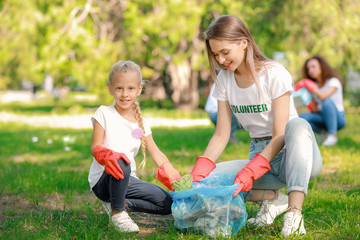 Volunteers gathering garbage in park