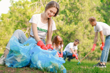 Female volunteer gathering garbage in park