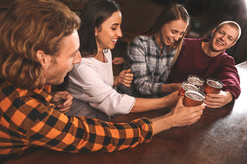 Friends drinking fresh beer in pub