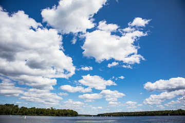 Clouds On A Sunny Day Juxtaposed With A Lake Setting