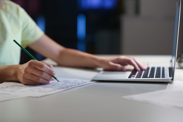 Female architect working at table in evening