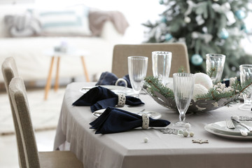 Festive table setting for Christmas dinner at home