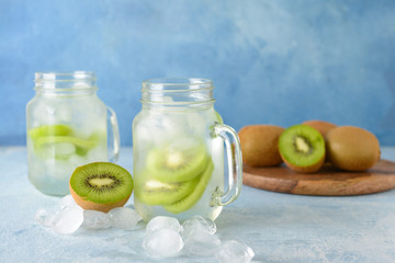 Mason jars of tasty kiwi cocktail on table