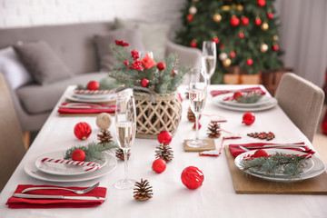 Beautiful table setting with Christmas decorations in living room