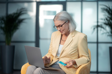 Concentrated woman sitting in front of a laptop