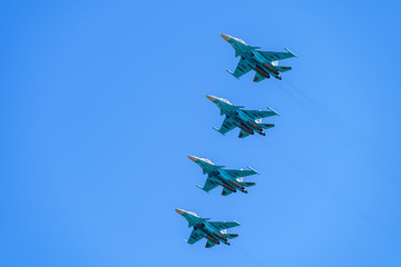 Airplanes with white smoke traces on air show. Pilots make tricks on Airforce jets at blue sky background