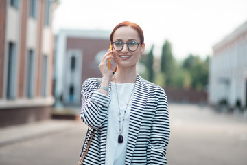 Fototapeta premium Pleased confident Caucasian young businesswoman in eyeglasses