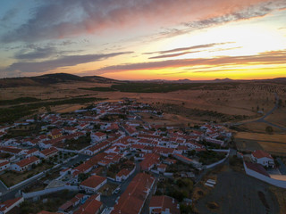 Aerial view from an amazing sunset in Alentejo, Portugal. With agricultural fields in background.