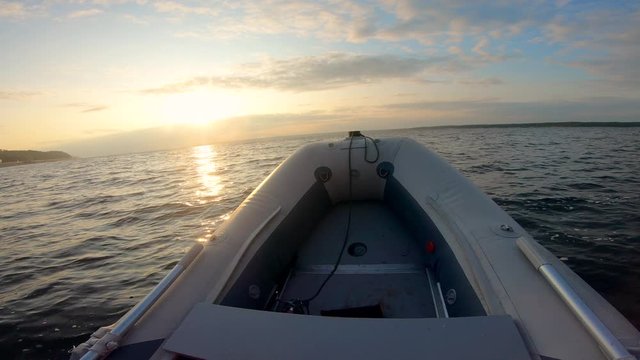 Sunset waters and motorboat's bow