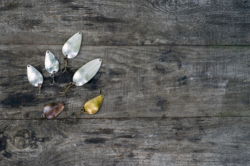 Metal spinners in the shape of a spoon of different colors for catching a predator on a vintage...