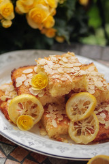 Lemon sponge cake with slices of lemons and almonds