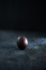 Dark purple eggs on a rough cement background