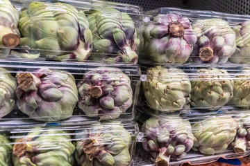 Fototapeta na wymiar Organic artichokes for sale in a supermarket shelf