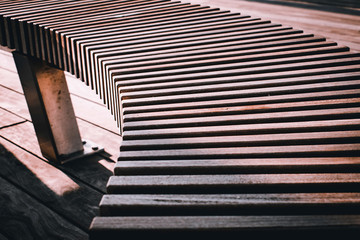 Sunny image of Wooden Bench, Bridge and Metal Railing Over Providence River in Rhode Island with...