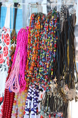 A lot of beads in different colors are selling on the outdoor fair. Ukrainian traditional handmade jewelry