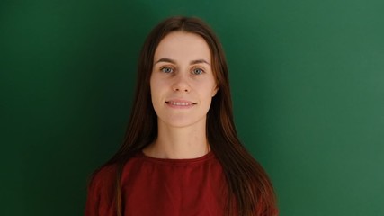 Happy young woman feels happiness, dance actively against green background, move emotionally, have fun. People sincere emotions lifestyle.