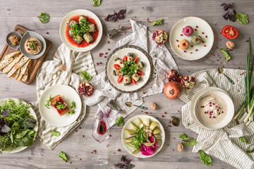 Food Table Celebration Delicious Party Meal Concept. A lot of food on the wooden table: meat, vegetables, desserts, garnishes.  Foodset from Georgian dishes. Caucasian food