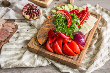 Food Table Celebration Delicious Party Meal Concept. A lot of food on the wooden table: meat, vegetables, desserts, garnishes.  Foodset from Georgian dishes. Caucasian food