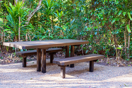 Casual Picnic Table And Seats In Outdoor Setting - Powered by Adobe