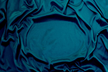 Photograph of silk fabric, color blue. The texture of silk fabric. Luxury silk fabric background...