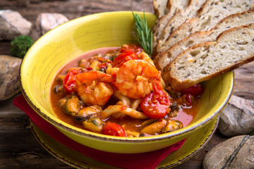 Seafood salad with tomato sauce: mussels, shrimps, calamari. Delicious diet rich in protein.