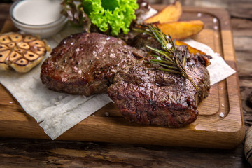 Neck steak, tenderloin or filet mignon pork or beef. Juicy tasty piece of meat. Delicious juicy steak.  A big piece of grilled meat.